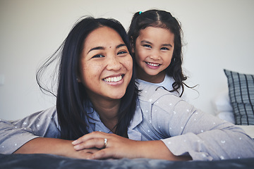 Image showing Portrait, mother and daughter in bed at home with love, care and happiness in morning. A young woman and girl child together in a bedroom for fun time, playing and security or relax in a family house