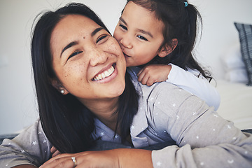 Image showing Kiss, mother and daughter in bed at home with love, care and happiness in morning. Portrait of a woman and girl child together in a bedroom for fun time, playing and security or relax in family house