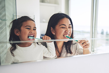 Image showing Mother, child and brushing teeth in morning routine, dental hygiene or healthcare together by mirror in bathroom. Happy mom and daughter cleaning mouth in tooth whitening, oral or gum care at home