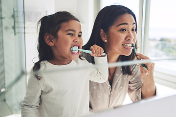 Image showing Mother, child and brushing teeth in dental cleaning hygiene, morning routine or healthcare together by mirror in bathroom. Happy mom and daughter mouth in tooth whitening, oral or gum care at home