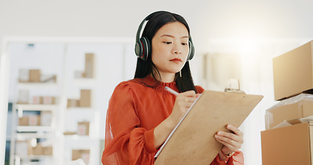 Image showing Business, fashion designer and Asian woman with checklist for planning, logistics and order delivery. Retail, commerce and girl listen to music for productivity for clothes, shipping and distribution