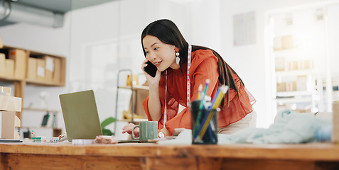 Image showing Phone call, laptop and creative with a designer asian woman at work in her fashion office for a style order. Contact, ecommerce and design with a female employee talking on her phone for retail