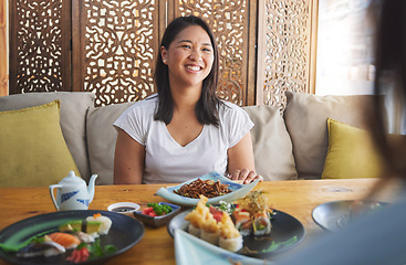 Image showing Sushi, restaurant and Japanese food with a woman smile with noodles and fish dish. Lunch, hungry Asian female person and Chinese meal with a friend happy from bonding and eating together at a table