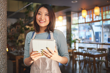 Image showing Restaurant, waitress and Asian woman on tablet for order for food service, inventory and sales. Coffee shop, small business and happy person, barista or manager on digital tech for cafe website