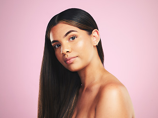 Image showing Portrait, hair and a natural woman on a pink background in studio for shampoo treatment. Face, beauty or haircare with a confident young model at the salon for organic skincare or keratin cosmetics