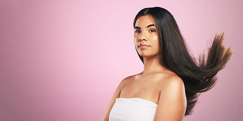 Image showing Beauty, hair and woman in studio with mockup for texture, treatment or shine on pink background. Haircare, glow and female model with healthy growth, results and strand strength, keratin or cosmetics