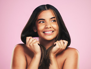 Image showing Beauty, hair and happy woman in studio for cosmetic, shampoo and results, treatment or satisfaction on pink background. Haircare, smile and female model with strand strength, growth or smooth texture