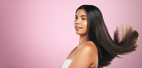 Image showing Hair, beauty and woman in studio with mockup for texture, treatment or shine on pink background. Haircare, glow and model profile with healthy growth, results or strand strength, keratin or cosmetics