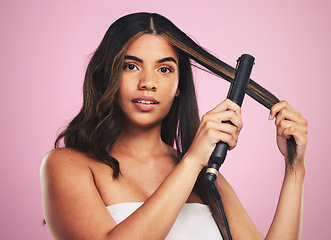 Image showing Portrait, woman and hair care with iron for studio beauty, cosmetic treatment or shine on pink background. Face of model, hairstyle or heating equipment of electric tools for smooth aesthetic texture