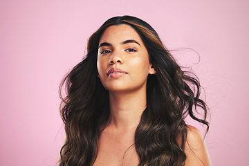 Image showing Portrait, hair care and woman with cosmetics, luxury or dermatology on a pink studio background. Face, person or female with volume, aesthetic or salon treatment with makeup, skincare or healthy skin