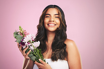 Image showing Happy woman, flowers and portrait in studio for skincare, natural cosmetics and aesthetic shine on pink background. Model smile for eco beauty with floral plants, sustainable dermatology and bouquet