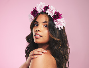 Image showing Woman, flower crown and portrait in studio for beauty, natural skincare and spring plants on pink background. Face, model and floral wreath for sustainability, eco dermatology and hair care cosmetics