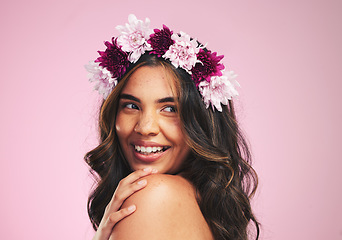 Image showing Happy woman, flowers and thinking with crown in studio for natural beauty, skincare and plants on pink background. Face, model and floral wreath for sustainability, eco dermatology and hair cosmetics