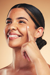 Image showing Skincare, beauty and woman with finger on face for wellness, health and facial care in studio. Dermatology, spa and happy person on brown background in cosmetics, natural glow and satisfaction touch