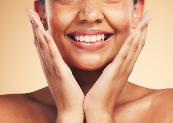 Image showing Skincare, smile and hands on woman face in studio for cosmetic, wellness and dermatology on brown background. Happy, beauty and lady model excited for glowing skin, results or self love cosmetology