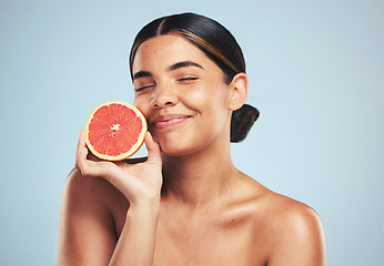 Image showing Skincare, smile and woman in studio with grapefruit for natural skin beauty or wellness on grey background. Happy, fruit and female model with citrus cosmetics for vitamin c, collagen and anti aging