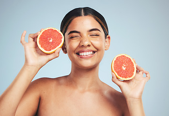 Image showing Happy, woman and grapefruit skincare in studio for natural, cosmetic and wellness on grey background. Face, smile and model with citrus, fruit and organic treatment for anti aging, glow or vitamin c