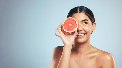 Image showing Skincare, grapefruit and woman in studio for natural cosmetic, treatment or beauty on grey background. Citrus, facial and model with fruit for vegan, detox and vitamin c, glowing skin or collagen