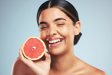 Image showing Happy, skincare and woman in studio with grapefruit for natural skin beauty or wellness on grey background. Smile, fruit and female model with citrus cosmetics for vitamin c, collagen and anti aging