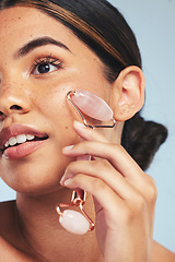 Image showing Skincare, derma roller and woman in studio with face massage for wellness, anti aging or circulation on grey background. Crystal, facelift and beauty model with rose quartz lymphatic drainage facial