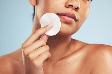 Image showing Woman, cotton pad and closeup of face for cosmetics, aesthetic glow and grooming on studio background. Model, beauty and skincare with dermatology for cleaning facial makeup, shine and cosmetology