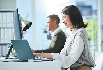 Image showing Business, research and asian woman on laptop and computer in office for planning or strategy in coworking space. Online, search and happy female designer smile for creative, networking or design