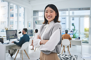 Image showing Happy, woman and Asian employee with arms crossed in office, workplace and confident in working for professional startup. Portrait, smile and person with pride and happiness in Singapore business