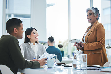 Image showing Tablet, training and manager in a meeting with employees speaking about business growth or development in an office. Planning, CEO and mature woman executive in discussion with team for collaboration