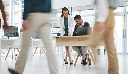 Image showing Collaboration, man and woman in busy office with laptop, advice and project management. Meeting at desk, opinion and businessman with mentor, business people walking and employees at startup agency.