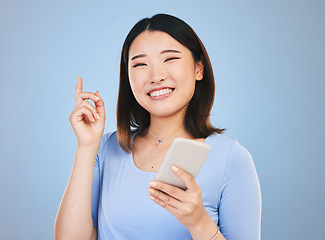 Image showing Woman, phone and idea, decision and portrait for university, college or education on blue background. Young asian person or student with solution or thinking on mobile for learning or chat in studio