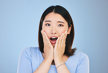 Image showing Asian, portrait and woman with surprise from announcement, news or horror story on blue background in studio. Shock, face and person with wow deal, discount or emoji for crazy promotion and offer