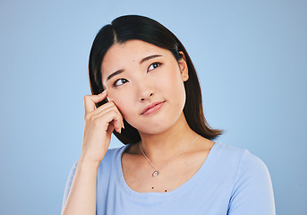 Image showing Decision, thinking and Asian woman with ideas, choice and problem solving on a blue studio background. Solution, Japanese person or model brainstorming, doubt and mockup space with questions or emoji