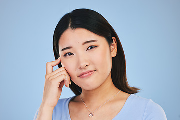 Image showing Portrait, thinking and Asian woman with ideas, solution and problem solving on a blue studio background. Face, Japanese person and model with a question, emoji and mockup space with brainstorming