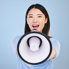 Image showing Woman, megaphone and voice for announcement, broadcast or student news and sale on blue background. Young asian person in portrait for call to action, university attention or college speech in studio