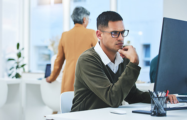 Image showing Business man, thinking and focus on computer for information technology, software development and solution. Professional worker reading with glasses for IT decision, programming or planning in office