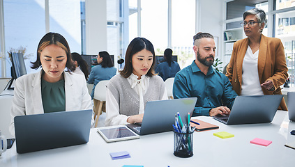 Image showing Business people, laptop and meeting, productivity and creative group at marketing agency with research online. Man, women and diversity, working together and senior team leader with branding strategy