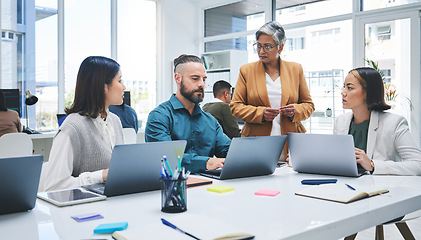 Image showing Business people, laptop and meeting, marketing team at digital agency, creative group and research online. Man, women and diversity, productivity and work together, senior leader and brand strategy