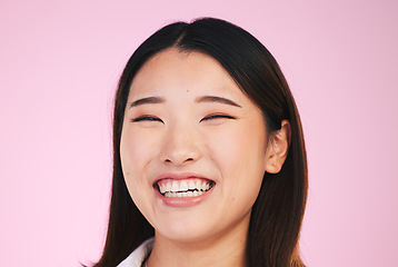 Image showing Happy, portrait and asian woman laugh in studio with funny, joke or silly humor on pink background. Comic, smile and face of female model laughing to goofy, comedy or playful, good mood or positivity