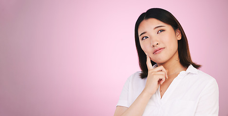 Image showing Asian woman, thinking and decision on mockup in problem solving against a pink studio background. Female person with idea, solution or choice in memory, reminder or brainstorming on mock up space