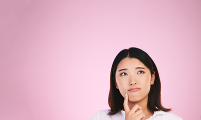 Image showing Asian woman, thinking and mockup space in solution, memory or ideas against a pink studio background. Female person in problem solving, reminder or plan emoji in decision or brainstorming on mock up