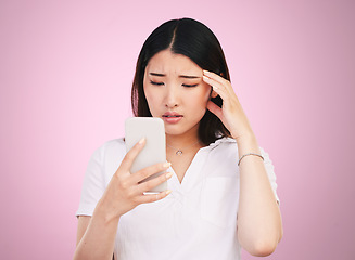 Image showing Search, phone and stress with face of woman in studio for networking, communication and worry. Social media, news and frustrated with asian person on pink background for technology and mobile app