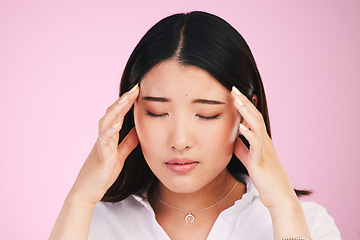 Image showing Asian woman, headache and stress in anxiety, tired or burnout against a pink studio background. Frustrated, upset or unhappy female person with migraine, injury or mental health pain on mockup space