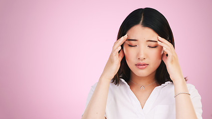 Image showing Asian woman, headache and stress in anxiety, burnout or tired against a pink studio background. Frustrated, upset or unhappy female person with migraine, injury or mental health pain on mockup space