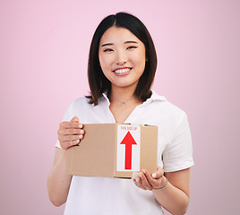 Image showing Woman, box and delivery, courier and e commerce with portrait and package isolated on pink background. Asian customer, commercial and supply chain with shipping, parcel and export service in studio