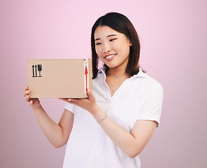 Image showing Happy asian woman, box and delivery in online shopping, supply chain or logistics against a pink studio background. Excited female person or shopper with package, parcel or cargo in ecommerce