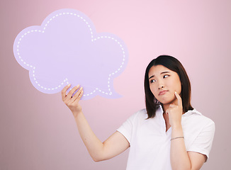 Image showing Asian woman, speech bubble and thinking on mockup space in quote or doubt against a pink studio background. Female person in problem solving with shape, icon or symbol in brainstorming or decision