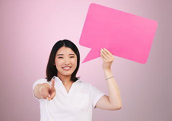 Image showing Asian woman, speech bubble and pointing to you on mockup space in choice against a pink studio background. Portrait of female person shape, icon or symbol in decision, selection or vote on mock up