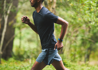 Image showing Man, speed and running in park for action, motion blur and power of cardio workout in nature. Closeup, runner and sports athlete in race for marathon with energy, exercise or fast performance outdoor