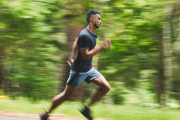 Image showing Sports man, action and running in park with speed, cardio workout or power of motion blur. Runner, athlete or training for marathon race with energy, dynamic exercise or fast performance pace outdoor