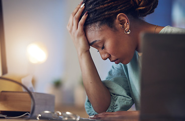 Image showing Business woman, depression and stress in an office at night working late on deadline. Tired African entrepreneur person with hands on head for pain, burnout or regret for mistake or fail at work